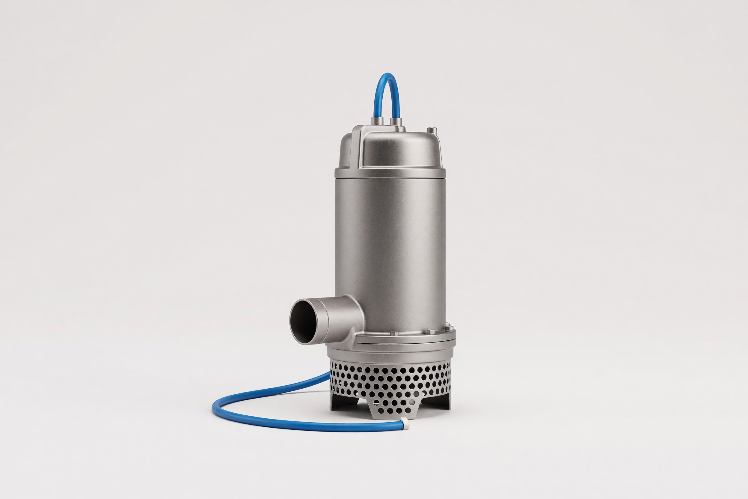 A submersible drainage pump on a clean studio ground